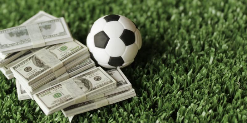 soccer football and money on field concept of gambling Tìm hiểu soi kèo trong bóng đá